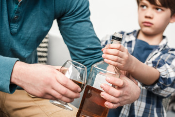 Boy and father alcoholic social problems concept son ask to stop drinking alcohol