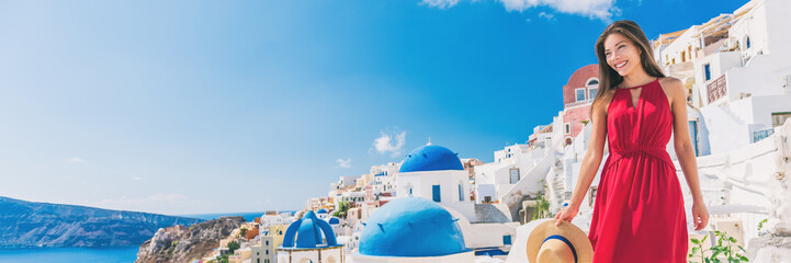 Europe summer vacation luxury tourist Asian woman walking in Oia city street, Santorini, Greece....