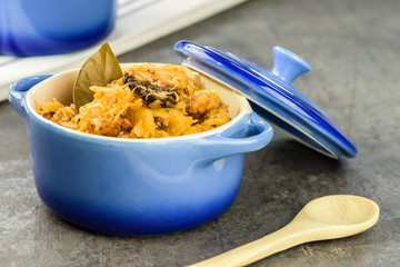Bigos - traditional Polish Easter and Christmas dish - closeup in blue bowl.