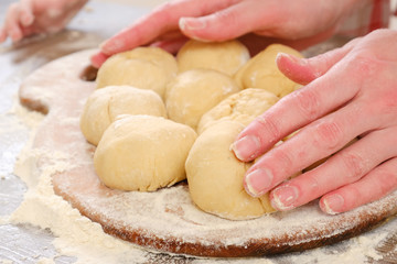 burithos dough for tortillas with flour and hand on table. Cooking burrito.