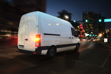 Fast van on a city road delivering at night. 3D Rendering - obrazy, fototapety, plakaty