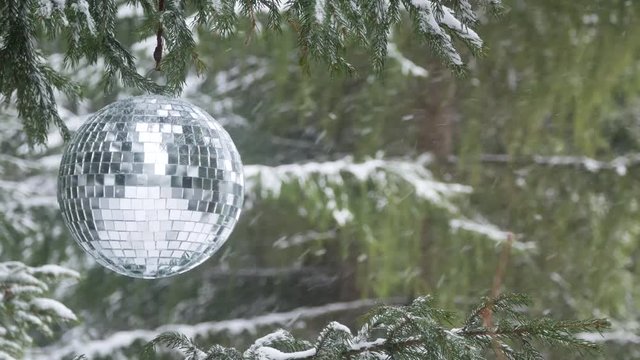 Mirror ball on the background of a winter forest