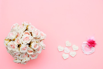 Heart symbol made of stone, white pink roses. Valentine's and mothers day background. Flat lay, top view