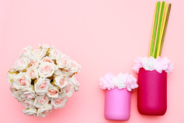 Bouquet of roses, flowers on the jars with pink background, mothers day celebration, flat lay top view