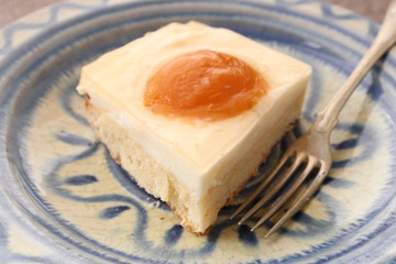 A piece of cake with cream and canned apricots. Pie - 