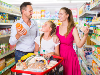 Happy family of three in the supermarket