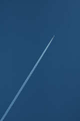 Airplane up in the sky diagonal to the right