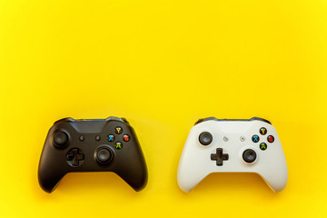 Black and white joystick on yellow background. Computer gaming competition videogame control confrontation concept © Юлия Завалишина