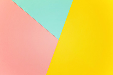 Blue, yellow and pink pastel color paper geometric flat lay background