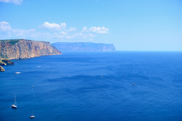 Fototapeta premium Seascape on a Sunny day. View of the sea and ships from the top of the mountain. Horizontal orientation