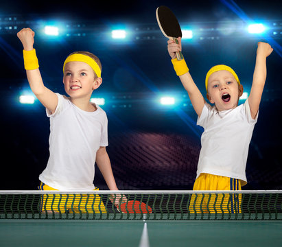 Two brothers play ping-pong.The joy of victory.