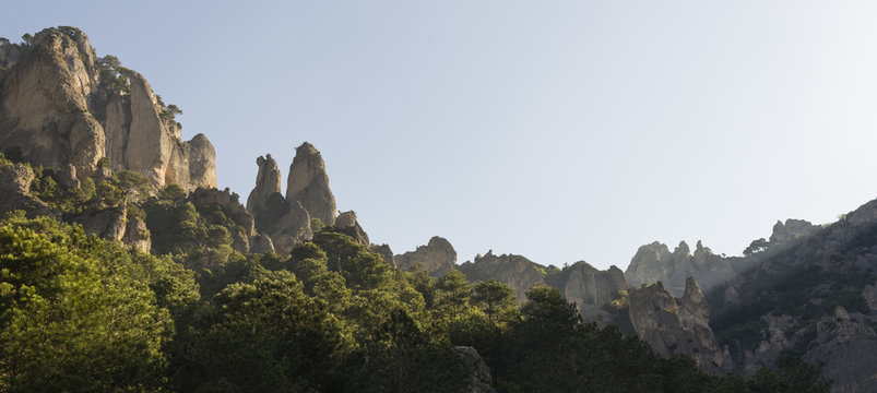landscape image at Puertos de Beceite national park showing the beautiful rocky hills with dense vegetation and nice morning sunlight
