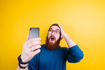 Shocked bearded man checking his phone