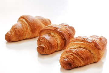 Homemade French Croissants isolated on white, selective focus