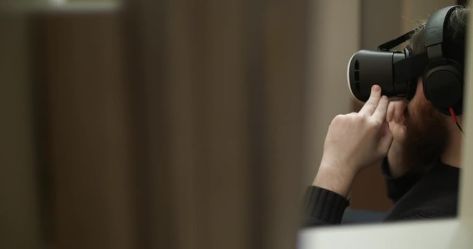 Creative bearded man uses virtual reality glasses