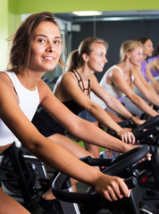 Fototapeta na wymiar Women cycling in fitness center