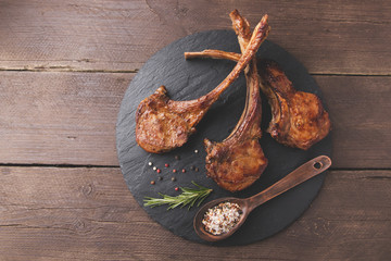 roasted lamb ribs loin chop on a stone surface © koss13