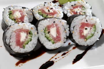 sushi with salmon and avocado in white plate