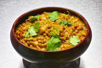 Moong Dal, indian vegetarian lentil soup in terra cotta bowl. - obrazy, fototapety, plakaty