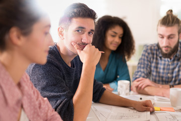 young man looking at the camera during a work meet