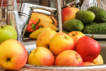 Apples in the kitchen under the water.