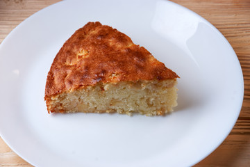 tasty apple pie slice on white plate