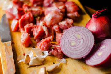 raw meat cut into pieces, pork prepared for cooking, red meat