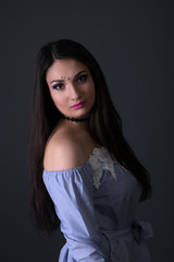 Young arabic woman  isolated on gray background