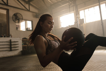 Woman exercising with medicine ball at gym
