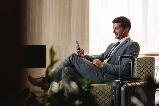 Business executive making a video call at airport lounge