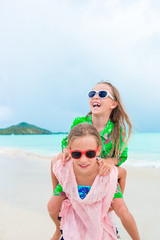 Adorable little girls enjoying time together on the beach