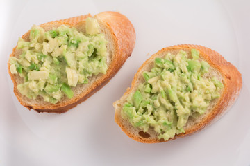 avocado bruschetta on white plate