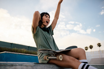 Female skateboarder enjoying herself at skate park © Jacob Lund