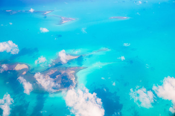 Fototapeta na wymiar Beautiful perfect view of exotic islands and turquoise water from airplane