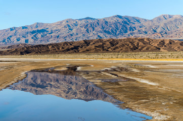 Amargosa Range - Rugged mountains of Amargosa Range reflecting in Spring creeks. Death Valley National Park, California, USA.