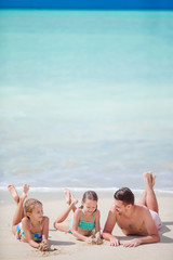 Father and little kids enjoying beach summer tropical vacation. Family playing on the beach