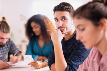 young man looking at the camera during a work meet