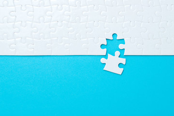 Blue background made from white puzzle pieces and place for your content - obrazy, fototapety, plakaty