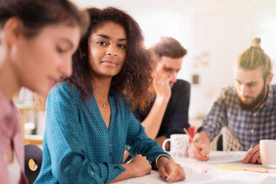 Portrait of a young black woman looking in a work meeting