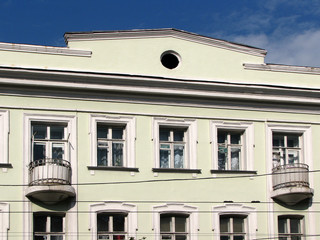 Obraz premium Classic building white facade with windows and circle balconies