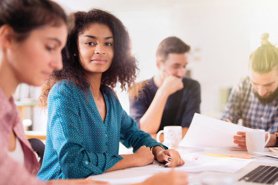 Portrait of a young black woman looking in a work meeting
