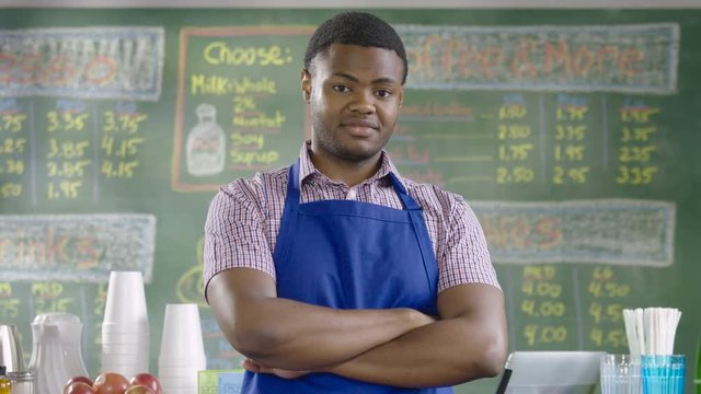 Portrait of a proud cafe worker, wide shot
