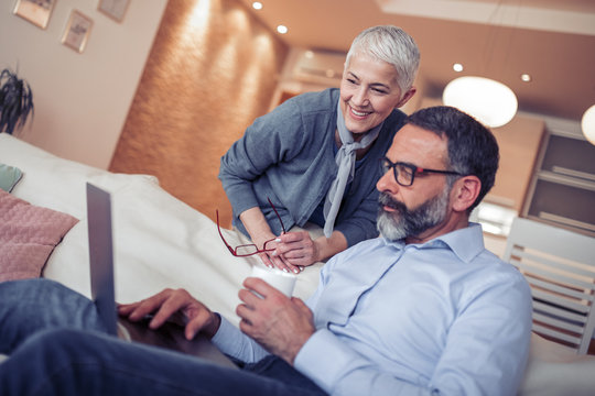 Mature Couple Using Laptop Computer At Home