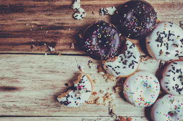 Picture of a small donuts on a wooden background. focus on donuts