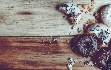 Picture of a small donuts on a wooden background. focus on donuts
