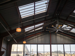 Industrial fan and windows with high ceiling in warehouse