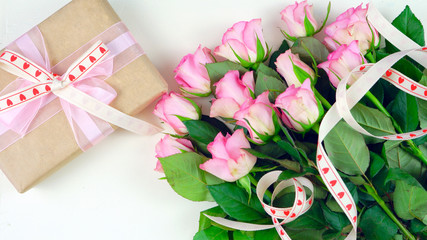 Happy Mother's Day overhead with gift and pink roses on white wood table background