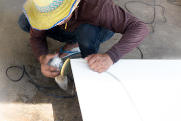 Worker Industrial tool hand grinder smoothing marble top