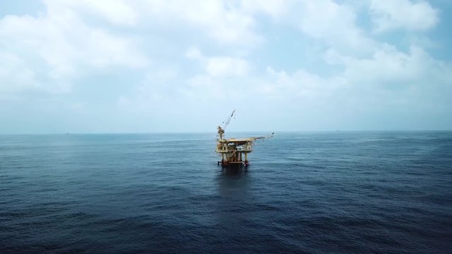 Aerial view from a drone of a small offshore platform in the middle of the ocean 

