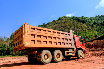 Obraz premium construction site digger, excavator and dumper truck. industrial machinery on building site, Dump truck is moving down sand on construction, truck on site